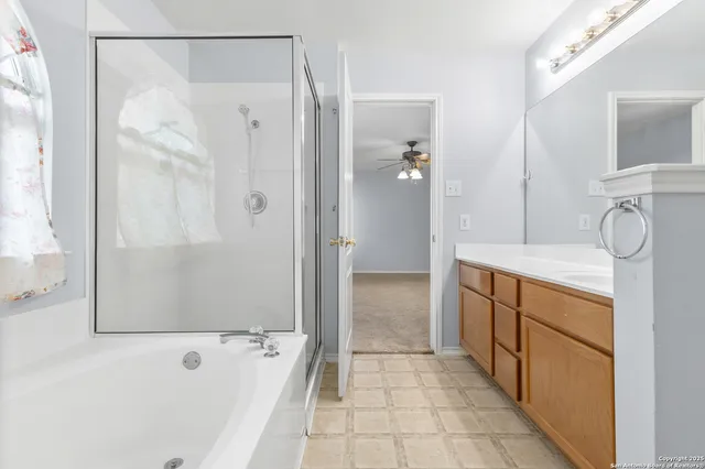 a bathroom with a tub sink and mirror