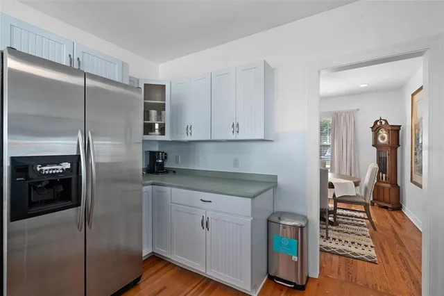 a kitchen with stainless steel appliances granite countertop a refrigerator and a stove top oven