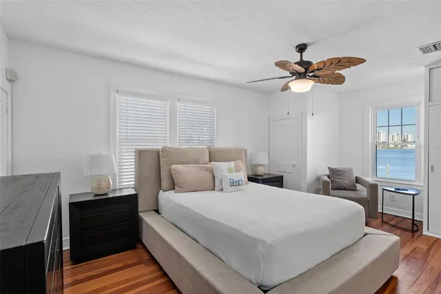a bedroom with a large bed and a chandelier