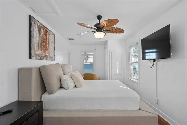 a bedroom with a large bed and a flat screen tv