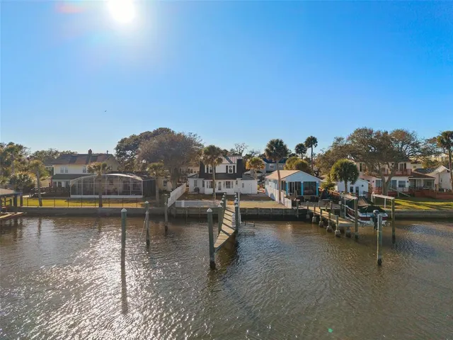 an aerial view of a houses with ocean view