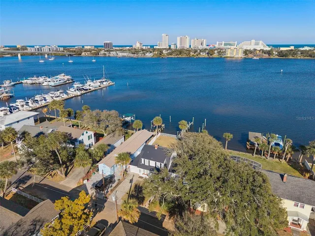 an aerial view of residential houses with city view