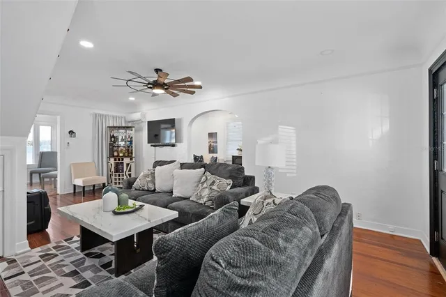 a living room with furniture a chandelier and a table