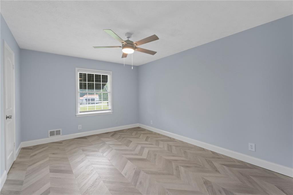2827 Highway 138 Conyers, GA 30013 - Photo 15 of 32 wooden floor in an empty room with a window