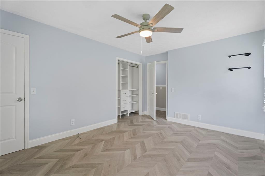 2827 Highway 138 Conyers, GA 30013 - Photo 19 of 32 an empty room with a ceiling fan and a window