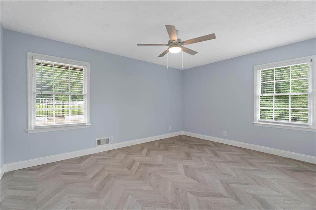 2827 Highway 138 Conyers, GA 30013 - Photo 20 of 32 an empty room with a window and a fan