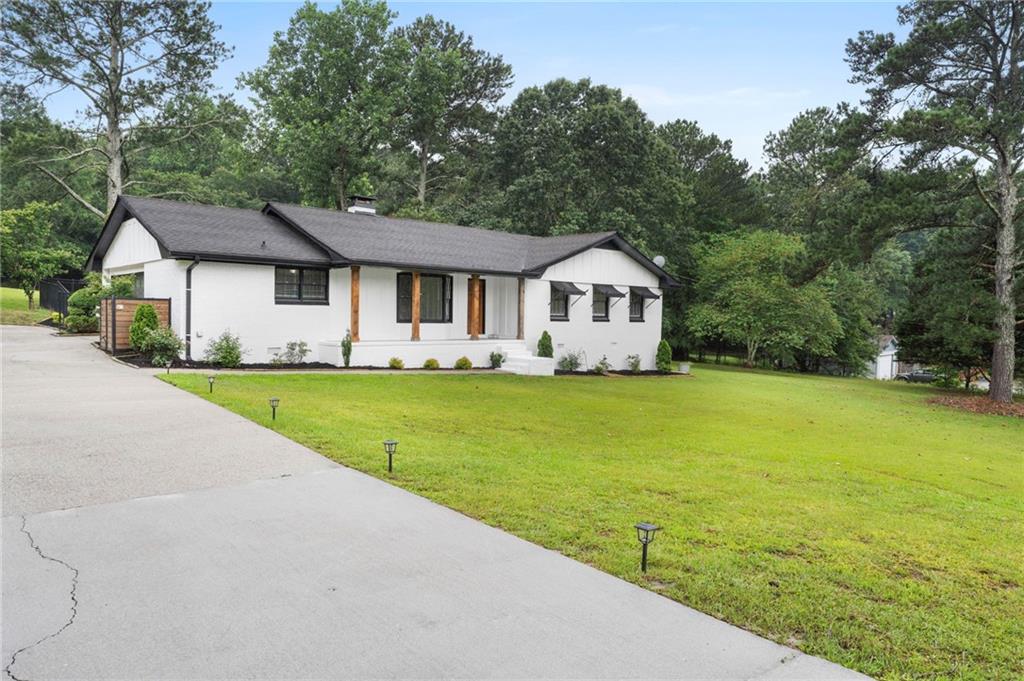 2827 Highway 138 Conyers, GA 30013 - Photo 2 of 32 a front view of a house with garden