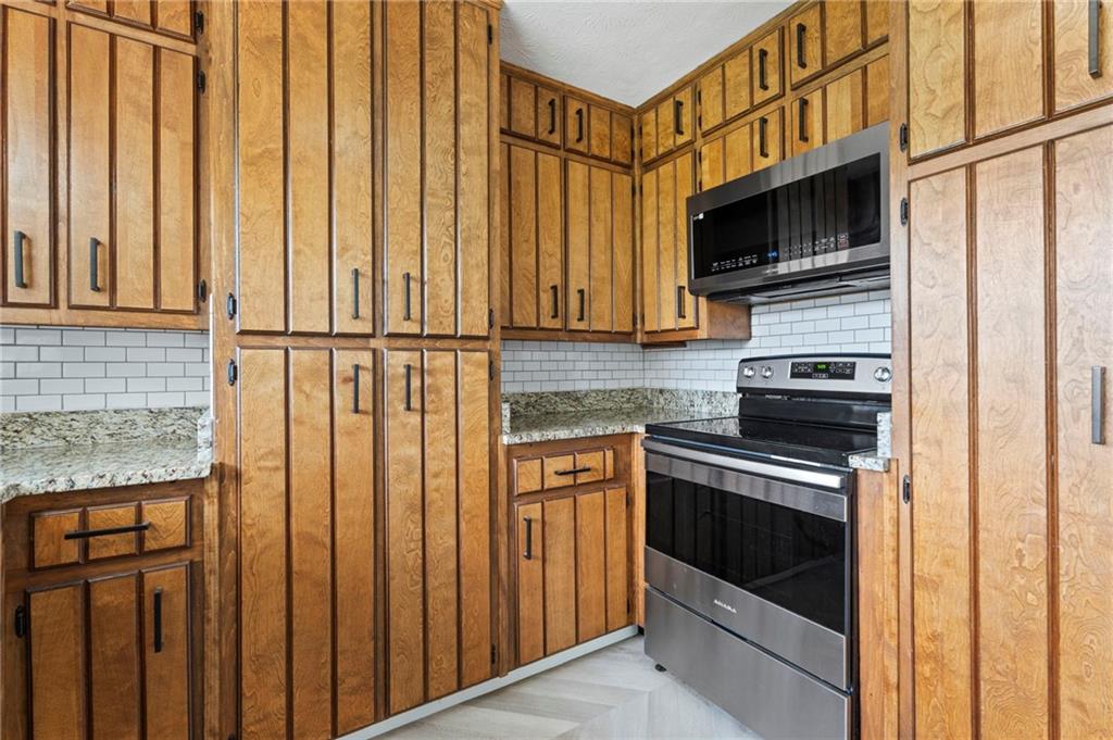 2827 Highway 138 Conyers, GA 30013 - Photo 32 of 32 a kitchen with stainless steel appliances cabinets and a window