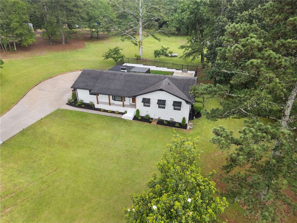 2827 Highway 138 Conyers, GA 30013 - Photo 4 of 32 a aerial view of a house with swimming pool and a yard