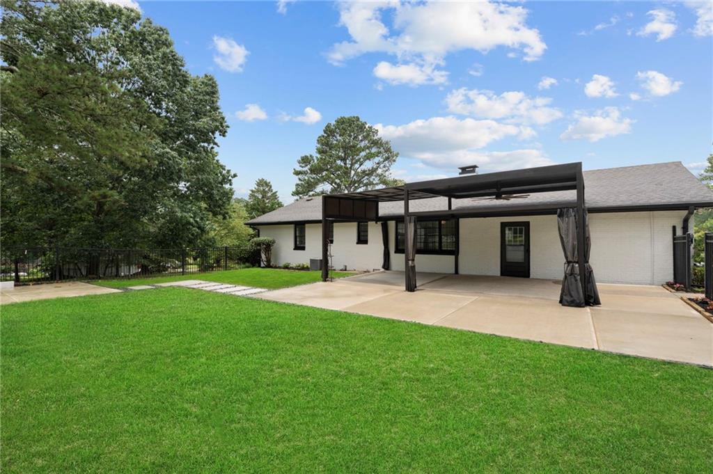 2827 Highway 138 Conyers, GA 30013 - Photo 9 of 32 a front view of a house with a garden and trees