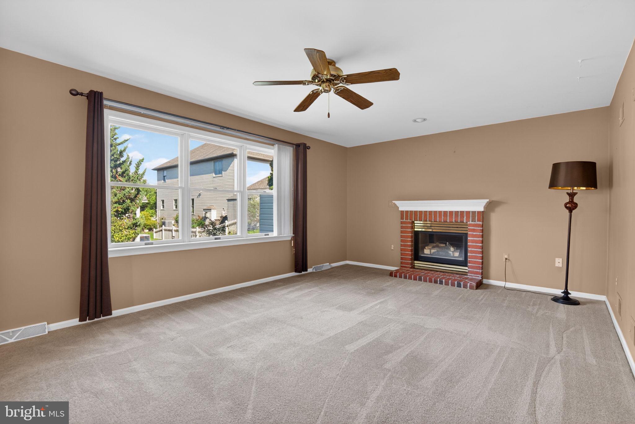 30 Red Maple Circle Palmyra, PA 17078 - Photo 10 of 38 Cozy gas fireplace w/brick surround warms the room