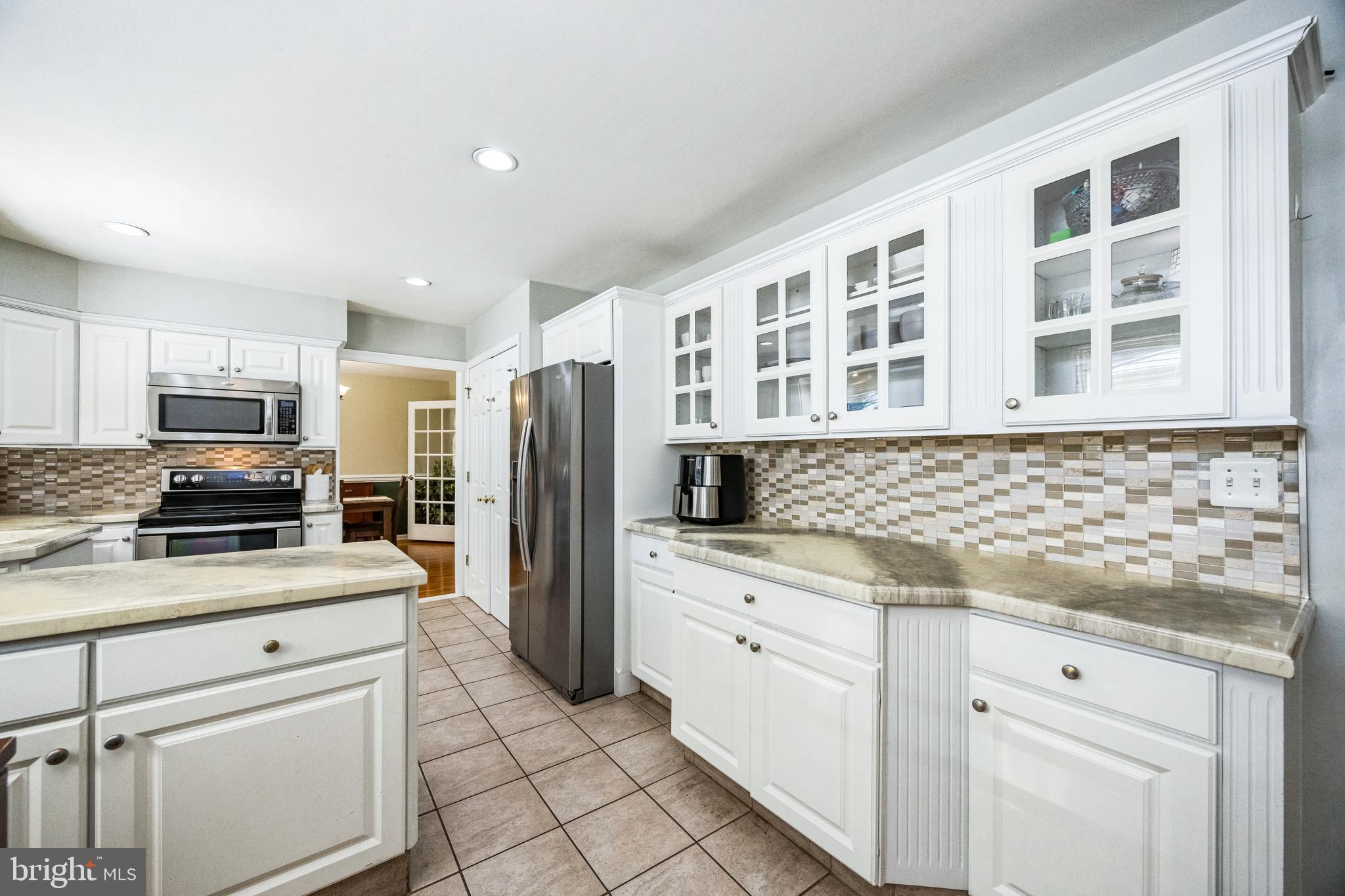 2016 Morris Drive Cherry Hill, NJ 08003 - Photo 9 of 31 a kitchen with stainless steel appliances kitchen island granite countertop a refrigerator stove and sink