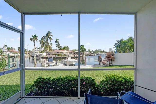 a view of a patio with table and chairs with wooden floor and fence