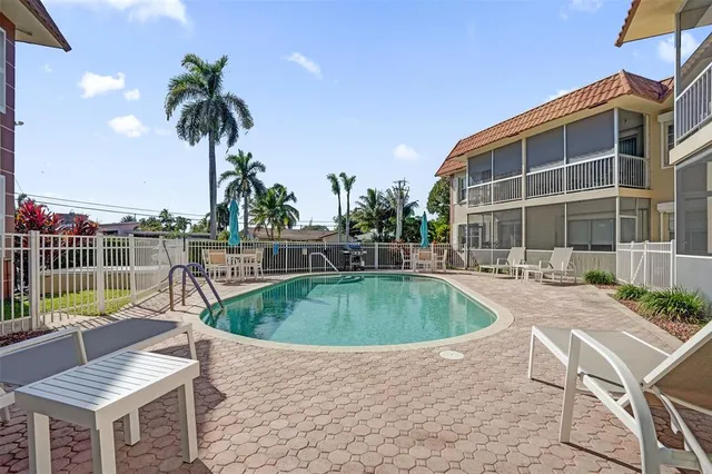 a view of a patio with a table and chairs