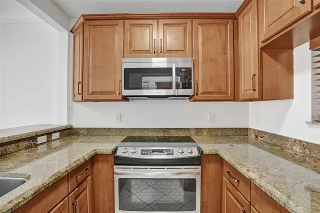 a kitchen with a sink stove and refrigerator