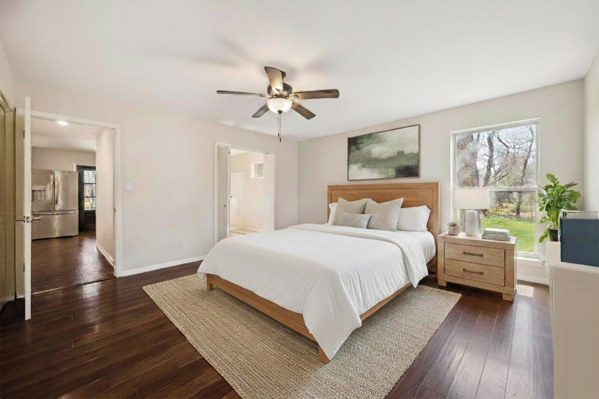 14311 Blidel Road Thompsons, TX 77469 - Photo 12 of 27 Alternate primary bedroom view showing open layout, ceiling fan, upgraded flooring, and access to en-suite bath.