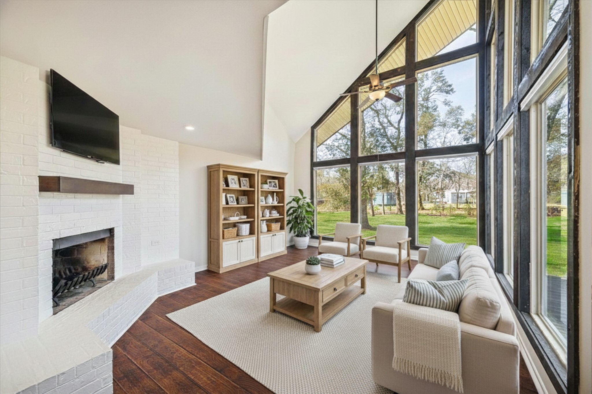 14311 Blidel Road Thompsons, TX 77469 - Photo 4 of 27 Living room with soaring vaulted ceilings, floor-to-ceiling windows, upgraded flooring, ceiling fan, and abundant natural light.