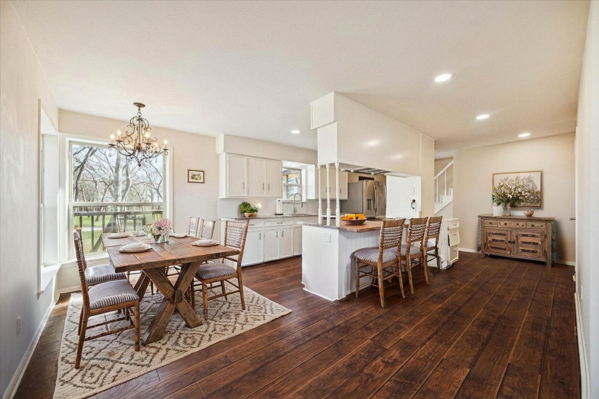14311 Blidel Road Thompsons, TX 77469 - Photo 7 of 27 Kitchen and breakfast area featuring granite countertops, center island, white cabinetry, recessed lighting, and adjacent dining space.