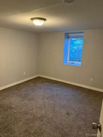 an empty room with a empty space and windows