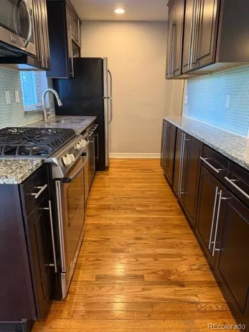 a kitchen with wooden cabinets and a stove top oven