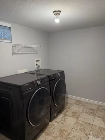 a utility room with sink dryer and washer