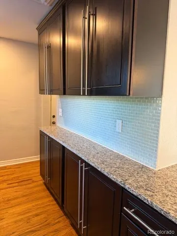 a kitchen with stainless steel appliances granite countertop cabinets and wooden floor