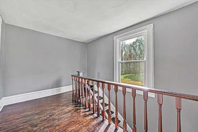 a bathroom with a toilet and a window