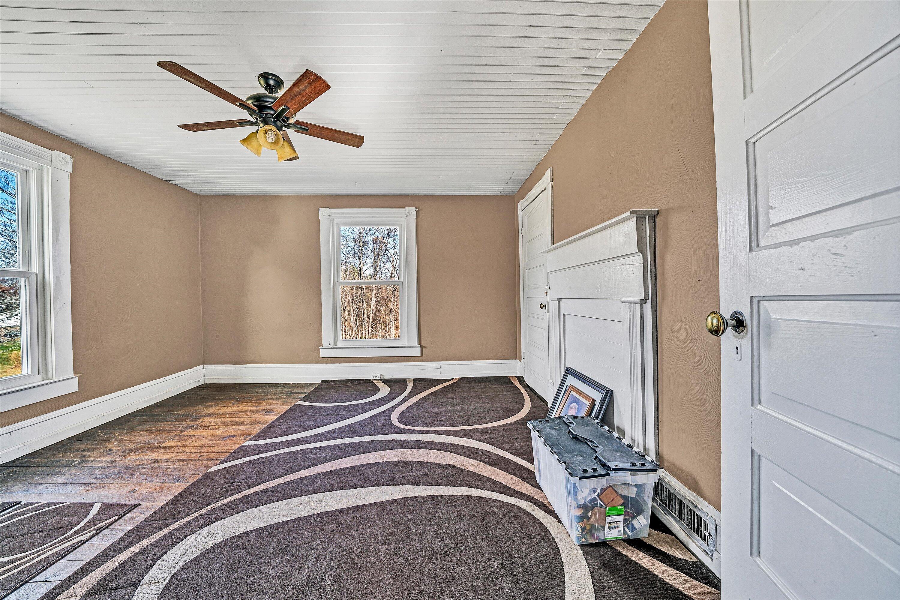 412 Wrays Chapel Road Rocky Mount, VA 24151 - Photo 16 of 25 a bedroom with a bed and a chandelier