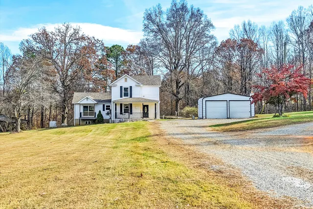 a yellow house sitting in middle of a yard