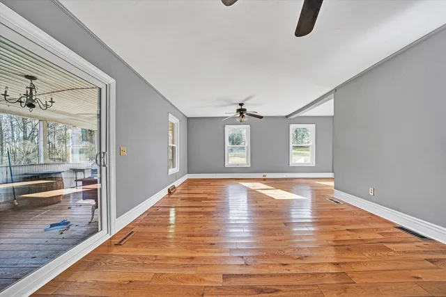 wooden floor in an empty room with a window