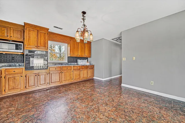 a view of a kitchen with a sink and cabinets