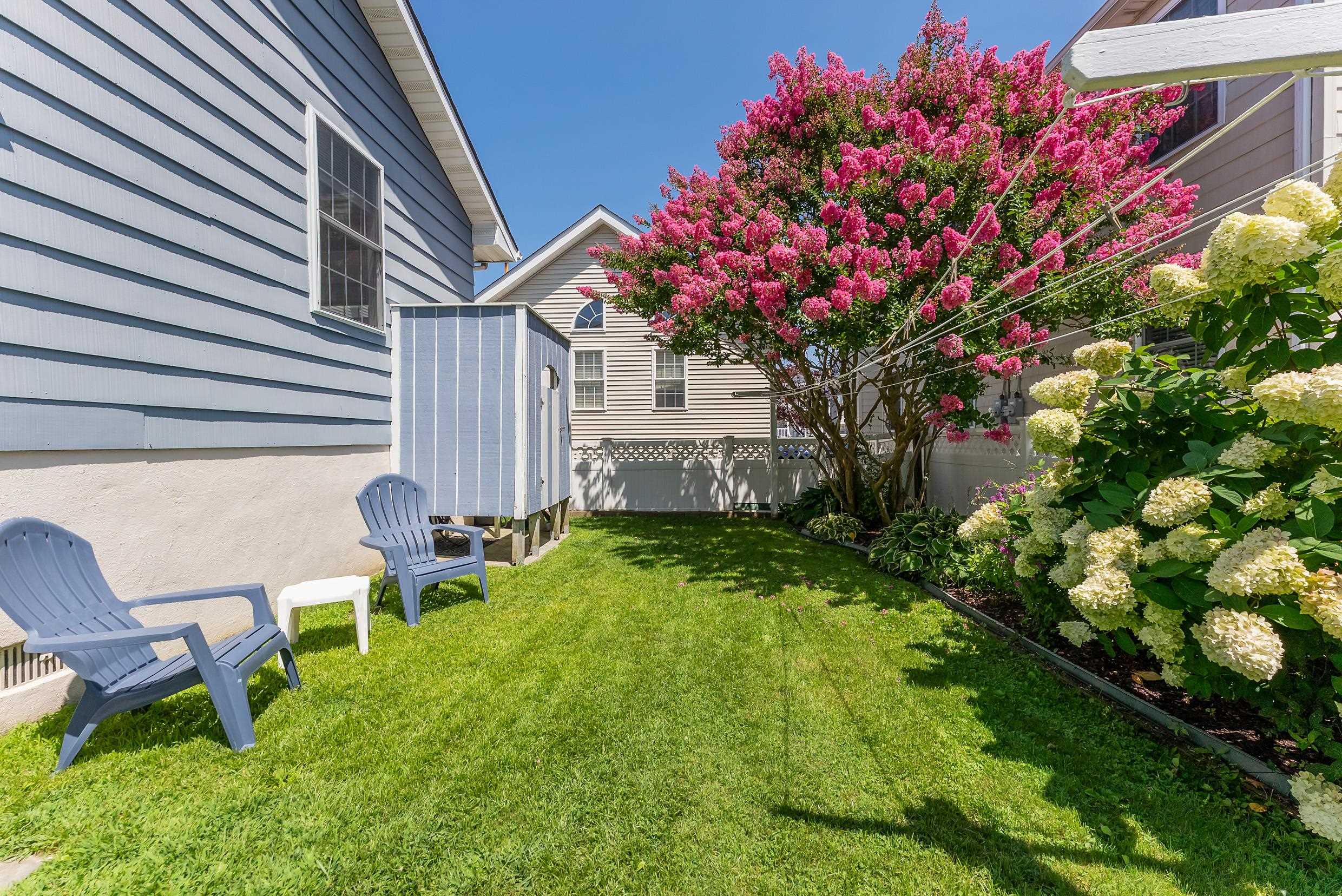 647 Barry Road Avalon, NJ 08202 - Photo 22 of 25 a backyard of a house with table and chairs