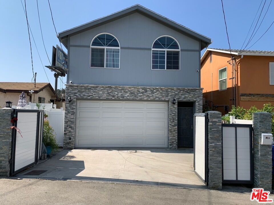 a front view of a house with garage