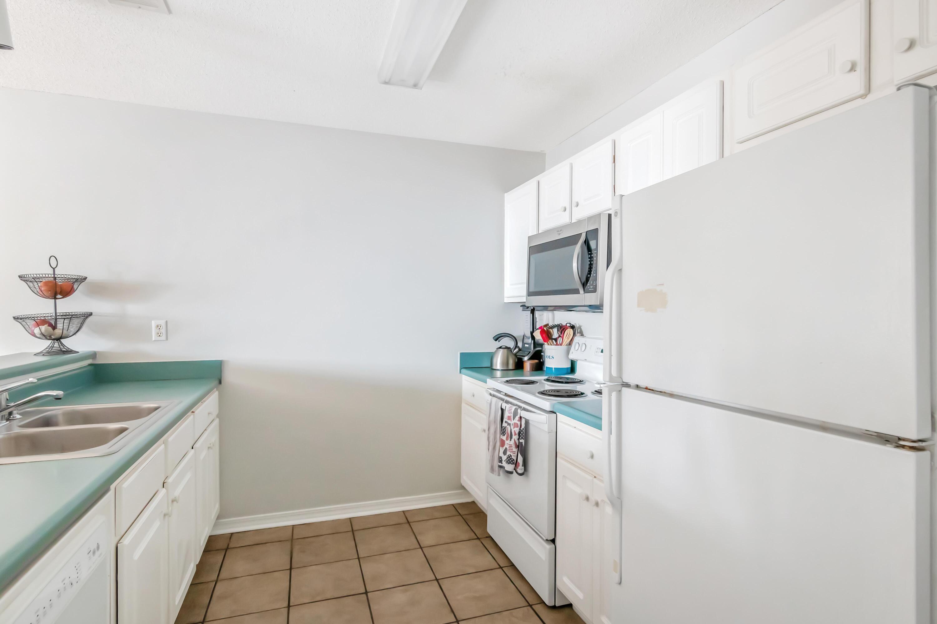 499 Keystone Road Mary Esther, FL 32569 - Photo 11 of 33 a kitchen with white cabinets and sink