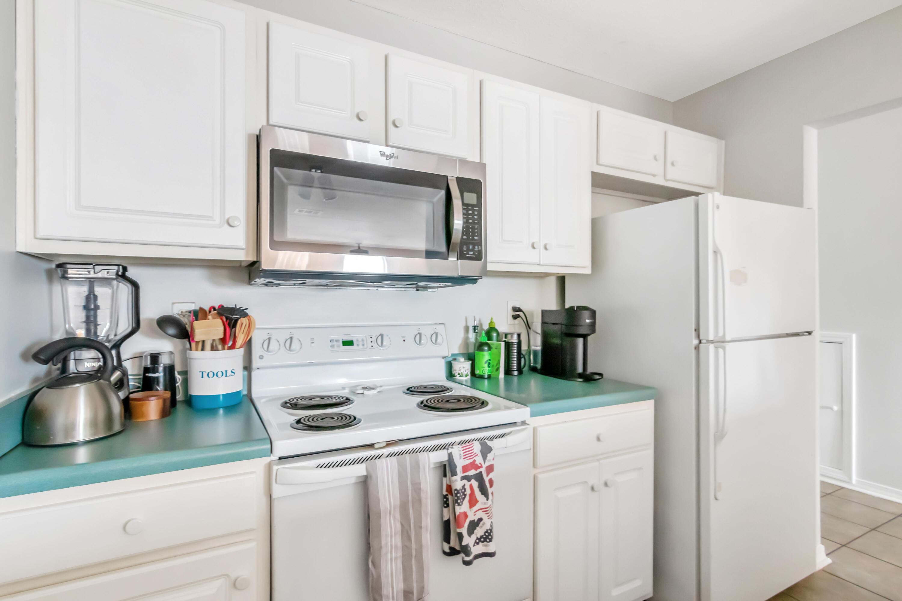 499 Keystone Road Mary Esther, FL 32569 - Photo 15 of 33 a kitchen with refrigerator a stove a sink and cabinets