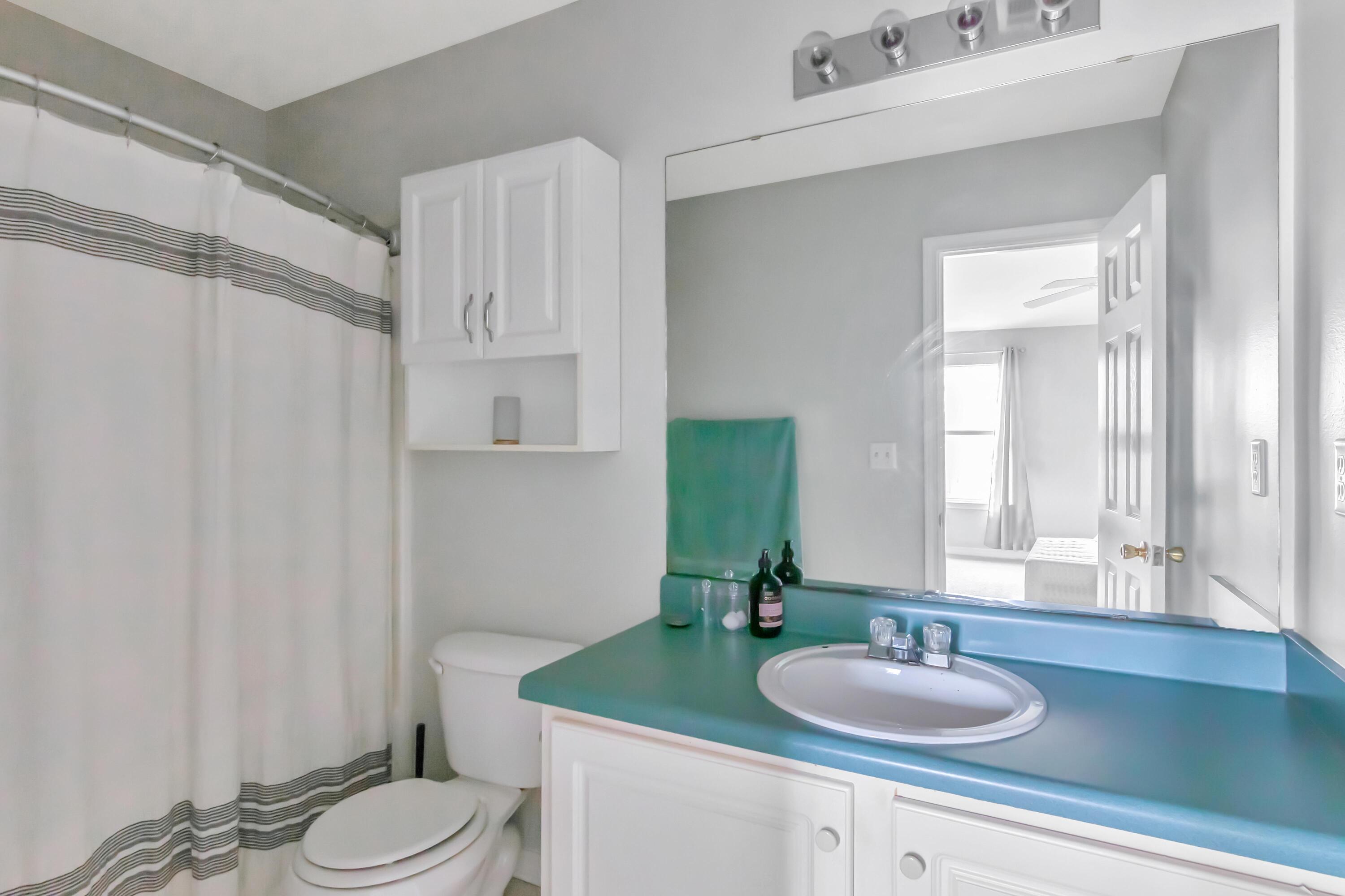 499 Keystone Road Mary Esther, FL 32569 - Photo 27 of 33 a bathroom with a granite countertop sink toilet and mirror