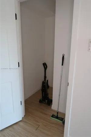 a view of a kitchen with cabinets and wooden floor