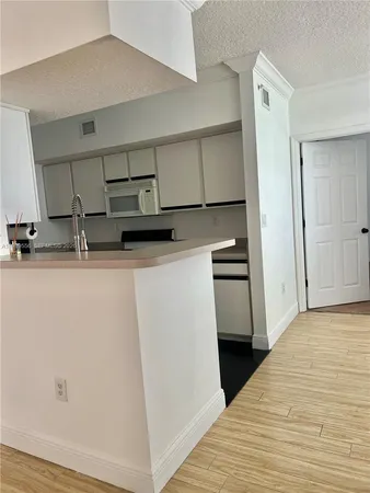 a kitchen with a sink and cabinets