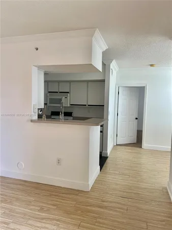 a kitchen with stainless steel appliances a sink stove and cabinets