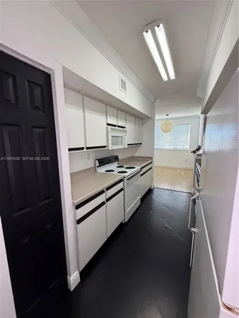 a kitchen with stainless steel appliances a sink stove and cabinets