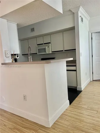 a view of a hallway view with wooden floor