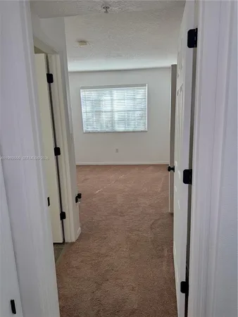 an empty room with an entrance to other room