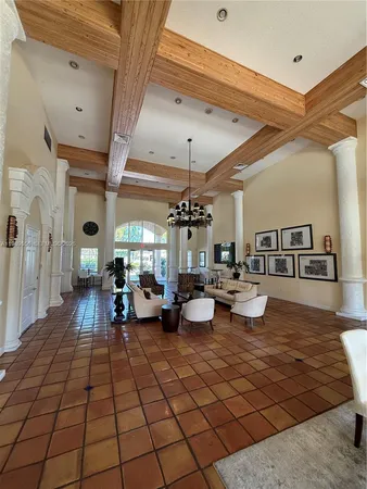 a living room with furniture a flat screen tv and a large window