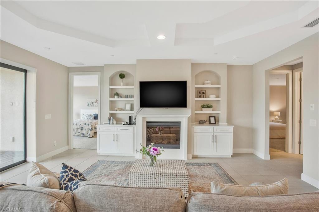 9650 Montelanico Loop, Unit 103 Naples, FL 34119 - Photo 11 of 29 a living room with furniture and a flat screen tv