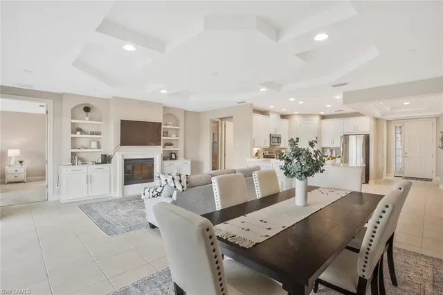 a dining room with furniture a fireplace and a flat screen tv