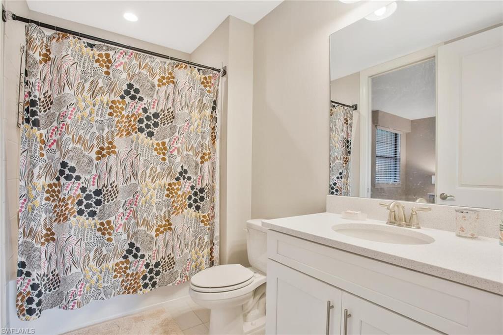 9650 Montelanico Loop, Unit 103 Naples, FL 34119 - Photo 16 of 29 a bathroom with a sink and a mirror