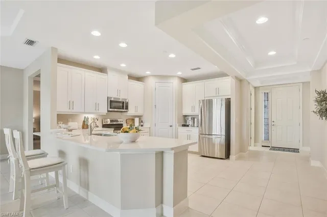 a kitchen with granite countertop white cabinets and white appliances