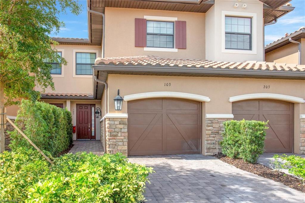 9650 Montelanico Loop, Unit 103 Naples, FL 34119 - Photo 2 of 29 a front view of a house with garden