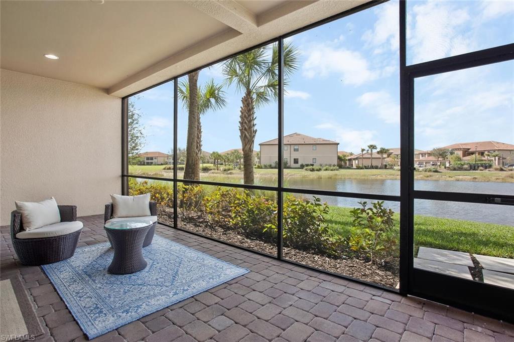9650 Montelanico Loop, Unit 103 Naples, FL 34119 - Photo 23 of 29 a view of a city from a room with large windows