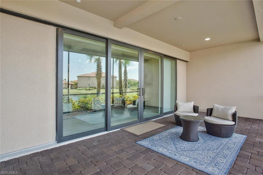 9650 Montelanico Loop, Unit 103 Naples, FL 34119 - Photo 24 of 29 a living room with furniture and a gate